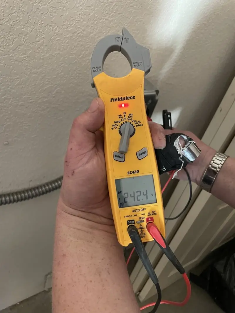 Voltage testing with clamp meter during Outlet Installation in Flora